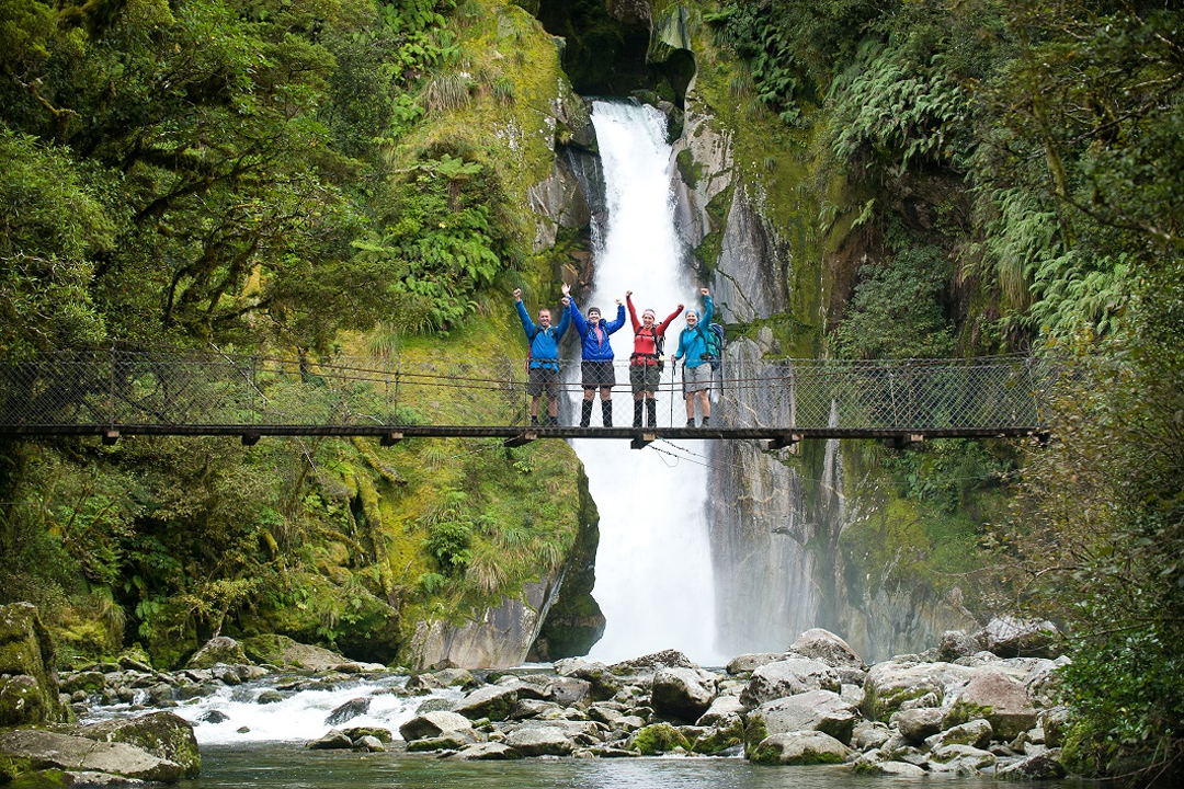 Fiordland Great Walk Tour People On Bidge Waterfall