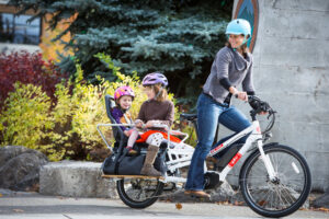Electric Cargo Bike Hire Full Day Mother Peddles With Children Seated In Back