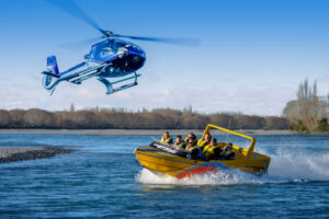 Helijet Experience Jet Boat With Helicopter Overhead
