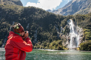 Private Fiordland Great Walk Package Man Takes Photo Of Waterfall