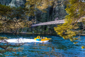 Private Kepler Jetboat And Hike Jetboat Navigates Under Bridge