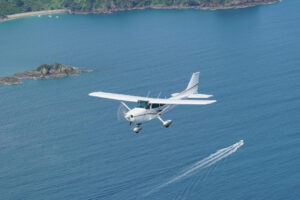 Waiheke Buzz Airplane Flys Over Water